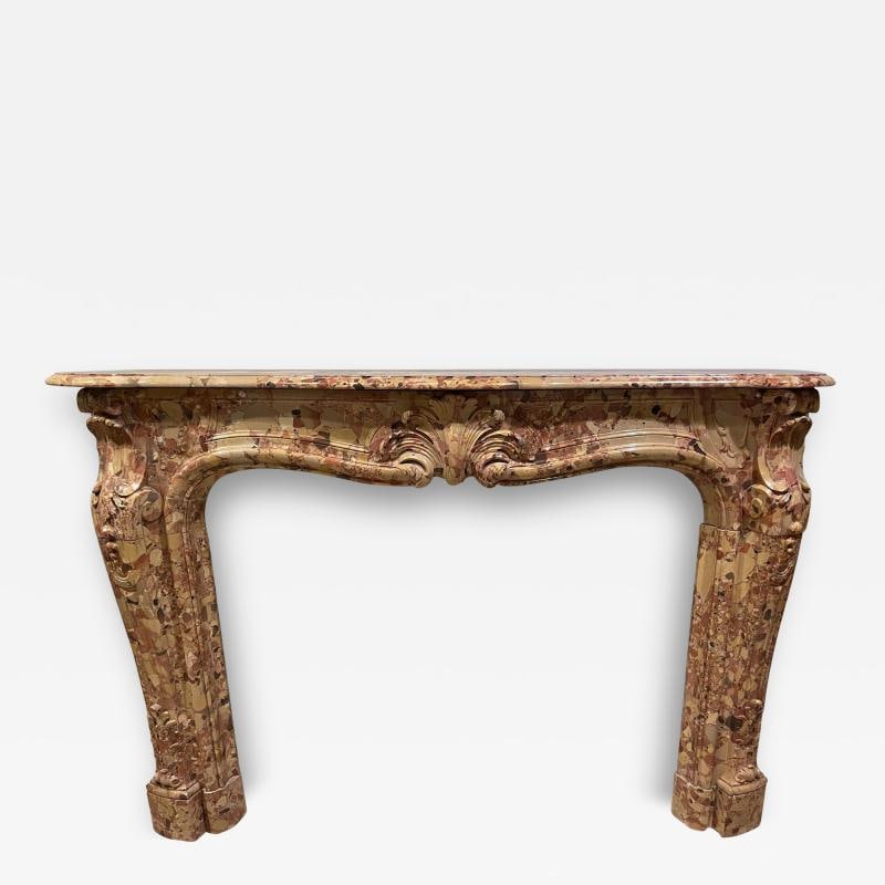 French Beige and Rouge Marble Fire Surround: Title: French Beige and Rouge Marble Fire Surround Description: French Louis XVI style Brèche de Sicile marble mantel surround with white veining, the serpentine shelf above a swept frieze with c