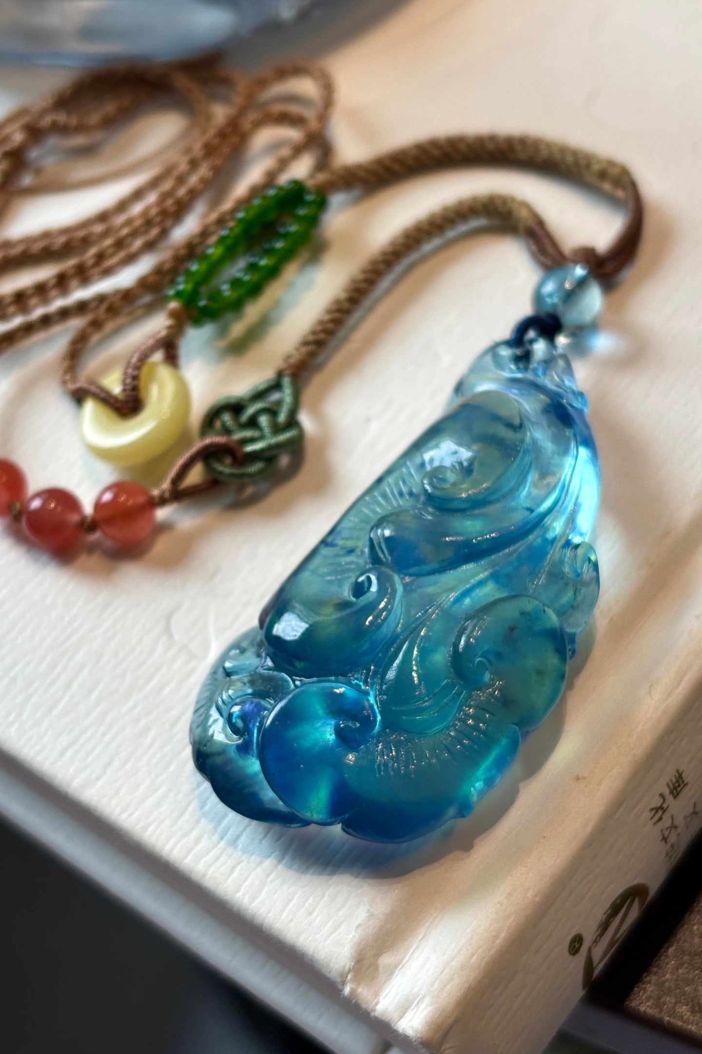 Natural Aquamarine Hand-Carved Ruyi Pendant with Certificate: Title: Natural Aquamarine Hand-Carved Ruyi Pendant with Certificate Origin: Chinese Date/Period: After2025 Materials: Aquamarine Dimensions: 52x25x13(mm) 2.05x0.98x0.51(inches) Weight 0.05 lbs/24g 
