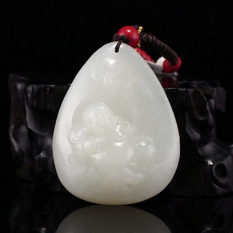 Hetian Jade Hand-Carved Laughing Buddha Pendant: Title: Hetian Jade Hand-Carved Laughing Buddha Pendant Origin: Chinese Date/Period: After2025 Materials: Hetian Jade Dimensions: 43x34x15(mm) 1.69x1.34x0.59(inches) Weight 0.07 lbs/34g Reserve: $150.0