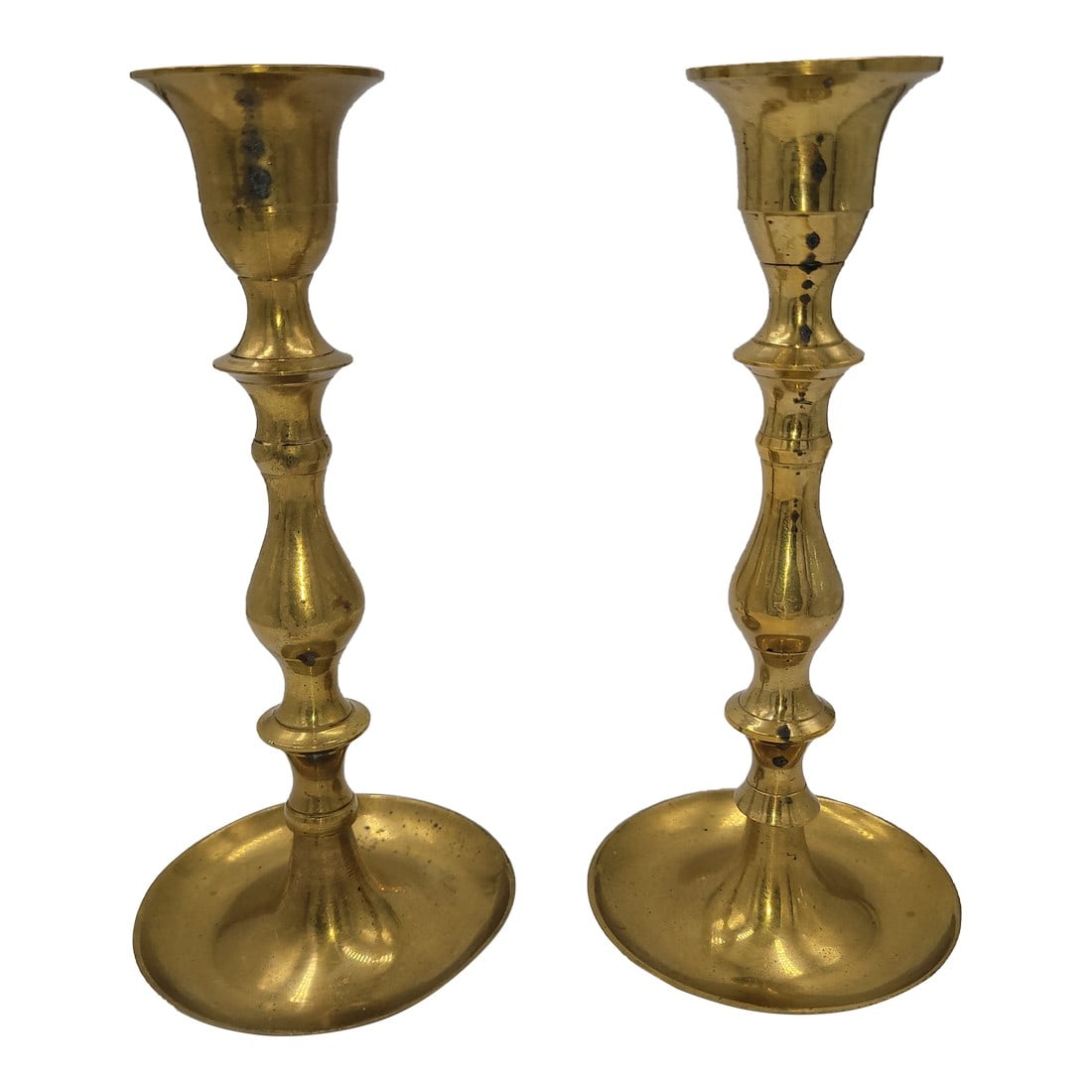 Pair of Mid 20th Century Brass Candlesticks: Illuminate your space with this charming pair of brass candlesticks, each standing at 6.5 inches tall and measuring 3 inches in diameter. Featuring a gracefully curved bottom base, these candlesticks