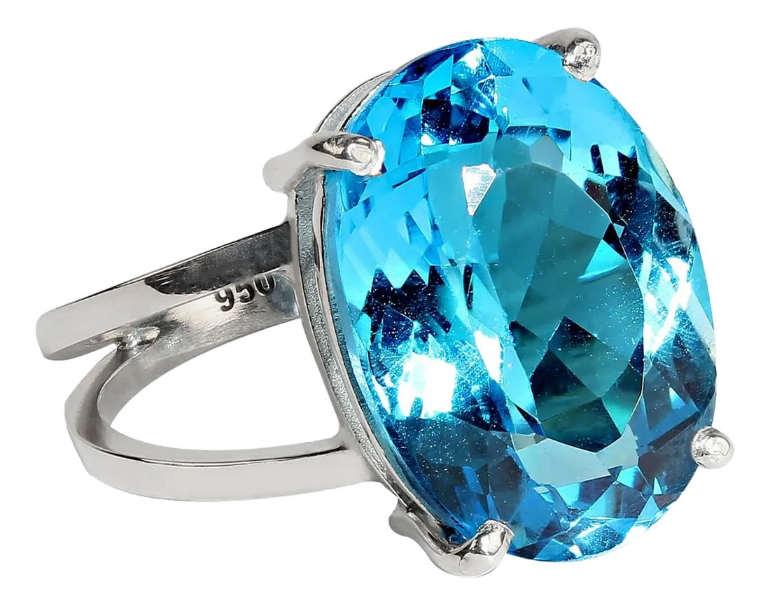 Scintillating 17ct Swiss Blue Topaz and Sterling Silver Ring: Introducing the Sparkling Swiss Blue Topaz and Handmade Sterling Silver Ring – a breathtaking piece of jewelry that exudes elegance and craftsmanship. This stunning ring features a brilliant 17.22CT