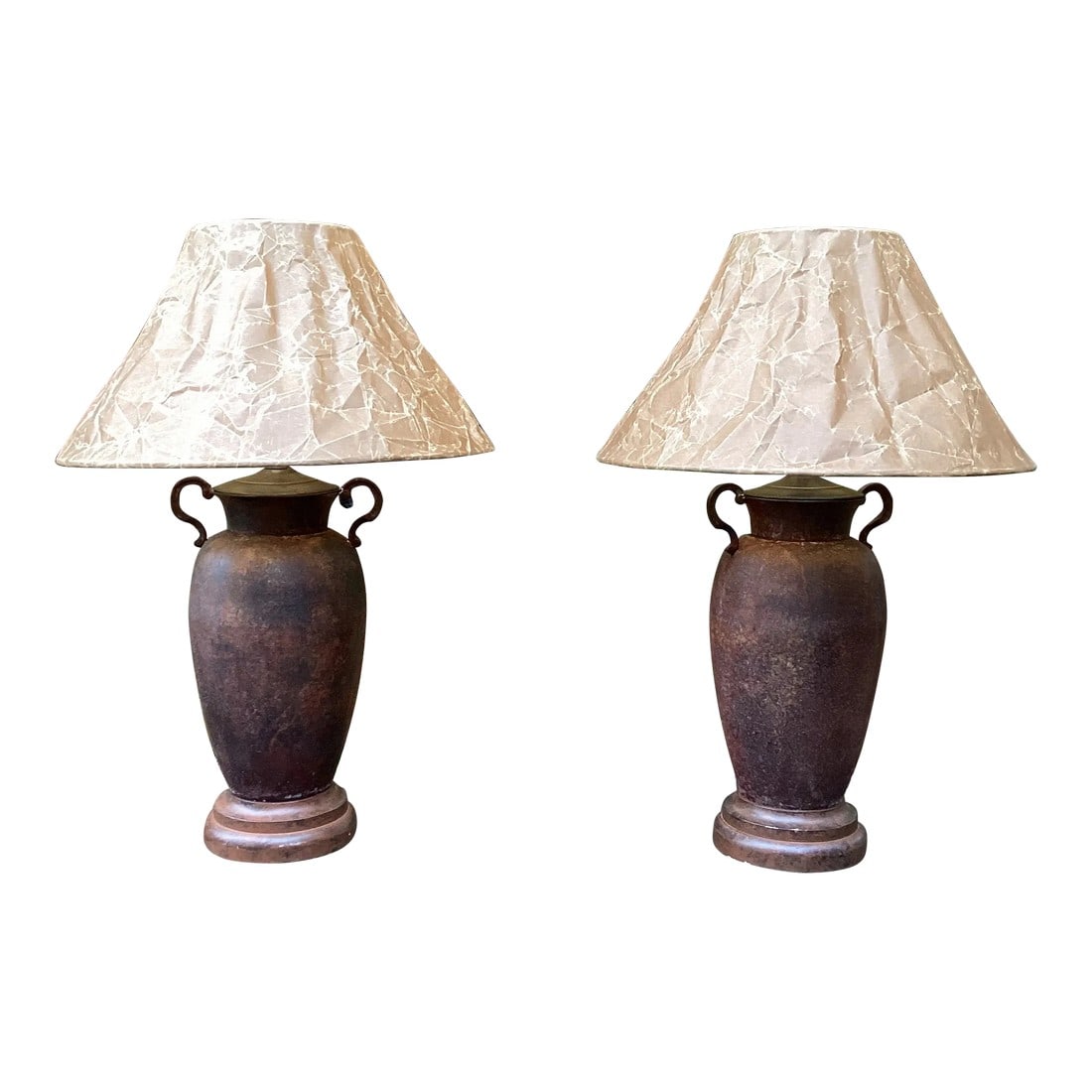 Pair of Late 20th Century Rusted Urns Mounted as Lamps With Crinkled Parchment Shades: Very rustic vibes on these small scale rusty urns. Great for your hunting lodge, lake house or man cave. 3 Way sockets and warm light filter through the distressed parchment. Warm, rustic and
