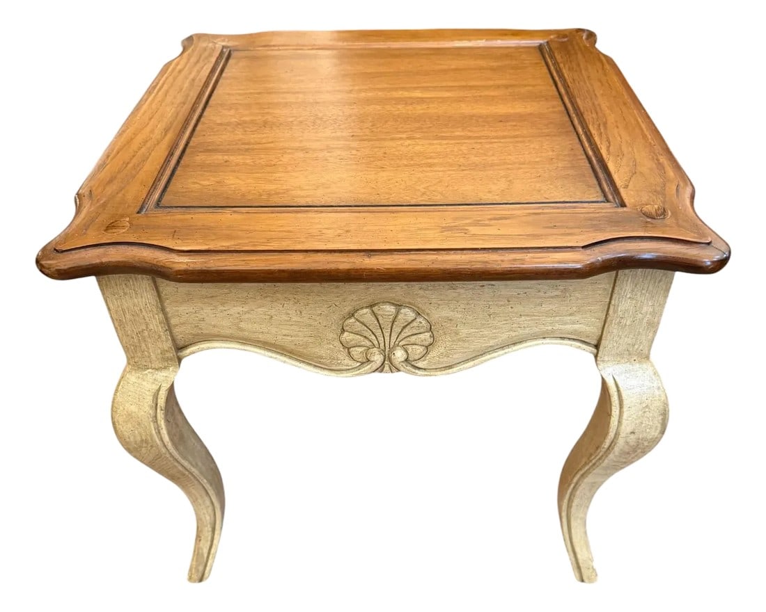 Hekman French Glass Top Side Table: Quick Hits: French Provincial-inspired side table by Hekman Cabriole legs with shell motif carvings Speckled cream and yellow finish with stained wood top Glass inset adds protection and polish Ideal