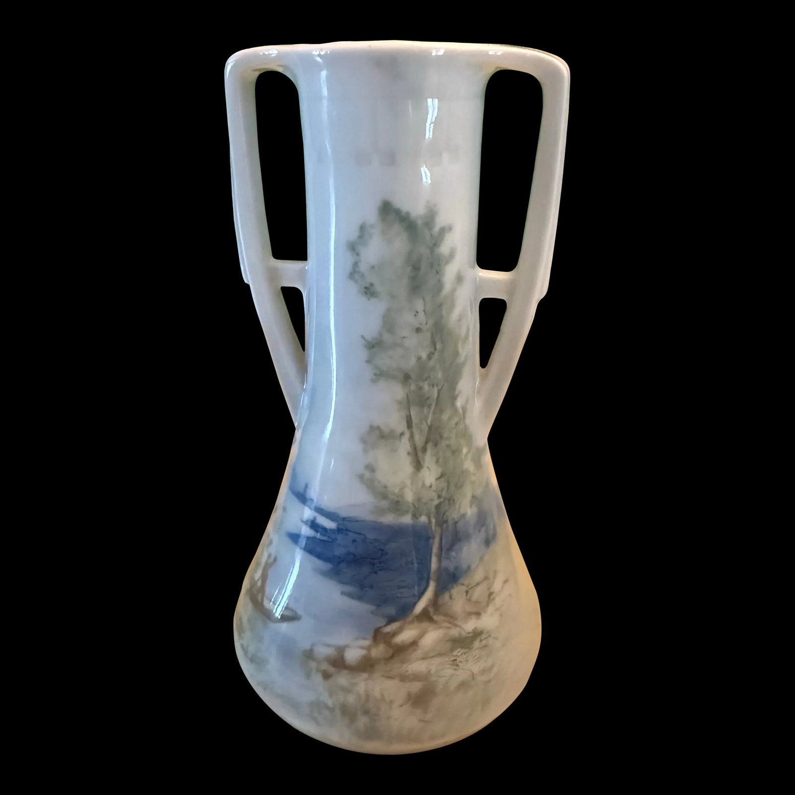 1900s Karl Ens, Volkstedt, Trophy Vase: Antique trophy style vase by Karl Ens from Germany. Hand painted porcelain depicts a lake scene in lovely blues and greens. You can see a small boat with a man navigating the water with a pole.