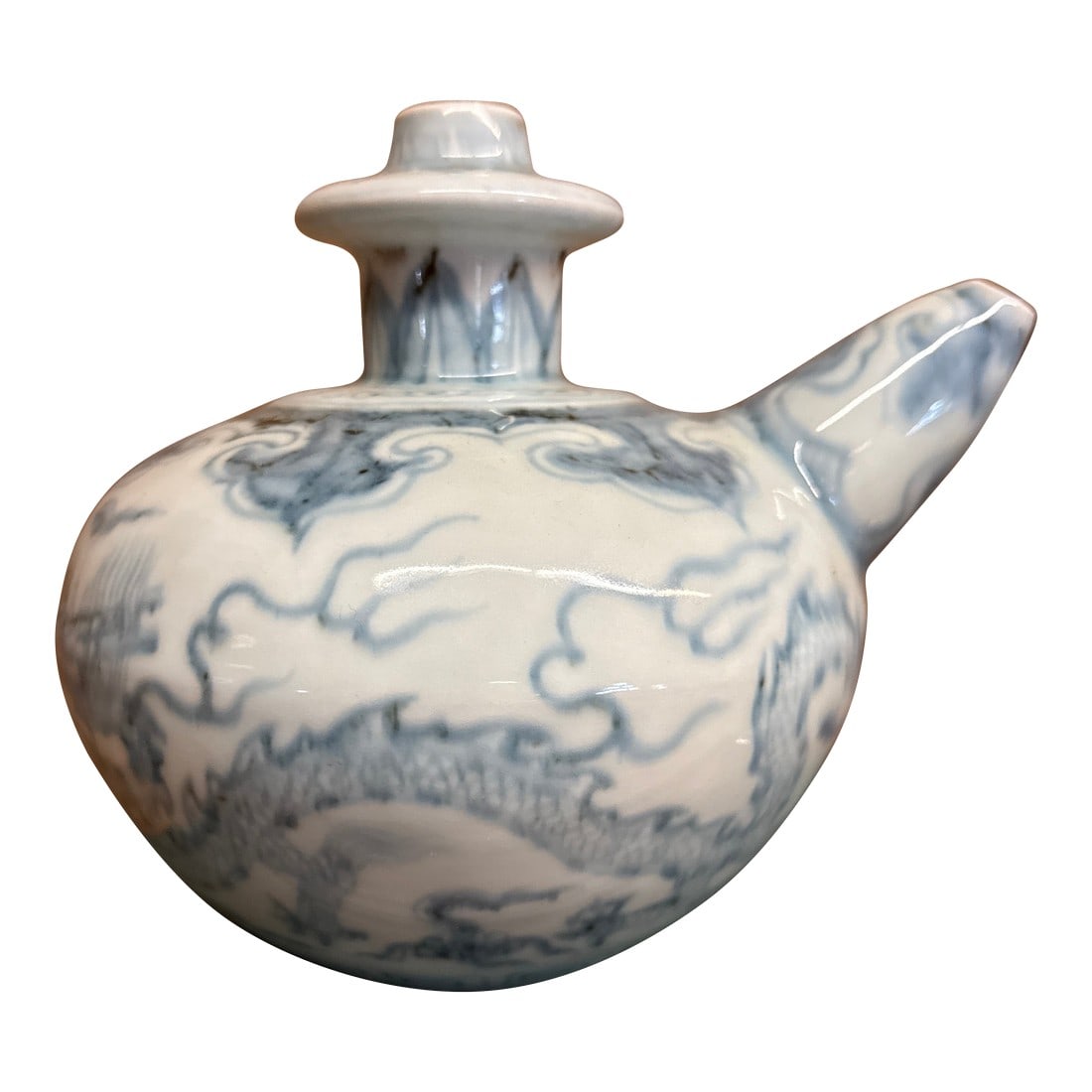 Kendi Dragon Motif Pouring Vessel Antique Asian Ceramic: 6" tall x 7.5 " long x 6 wide Blue and white glaze with dragon motif. In excellent condition. Condition: Alterations: Original Condition Unaltered Imperfections: Some Imperfections Condition
