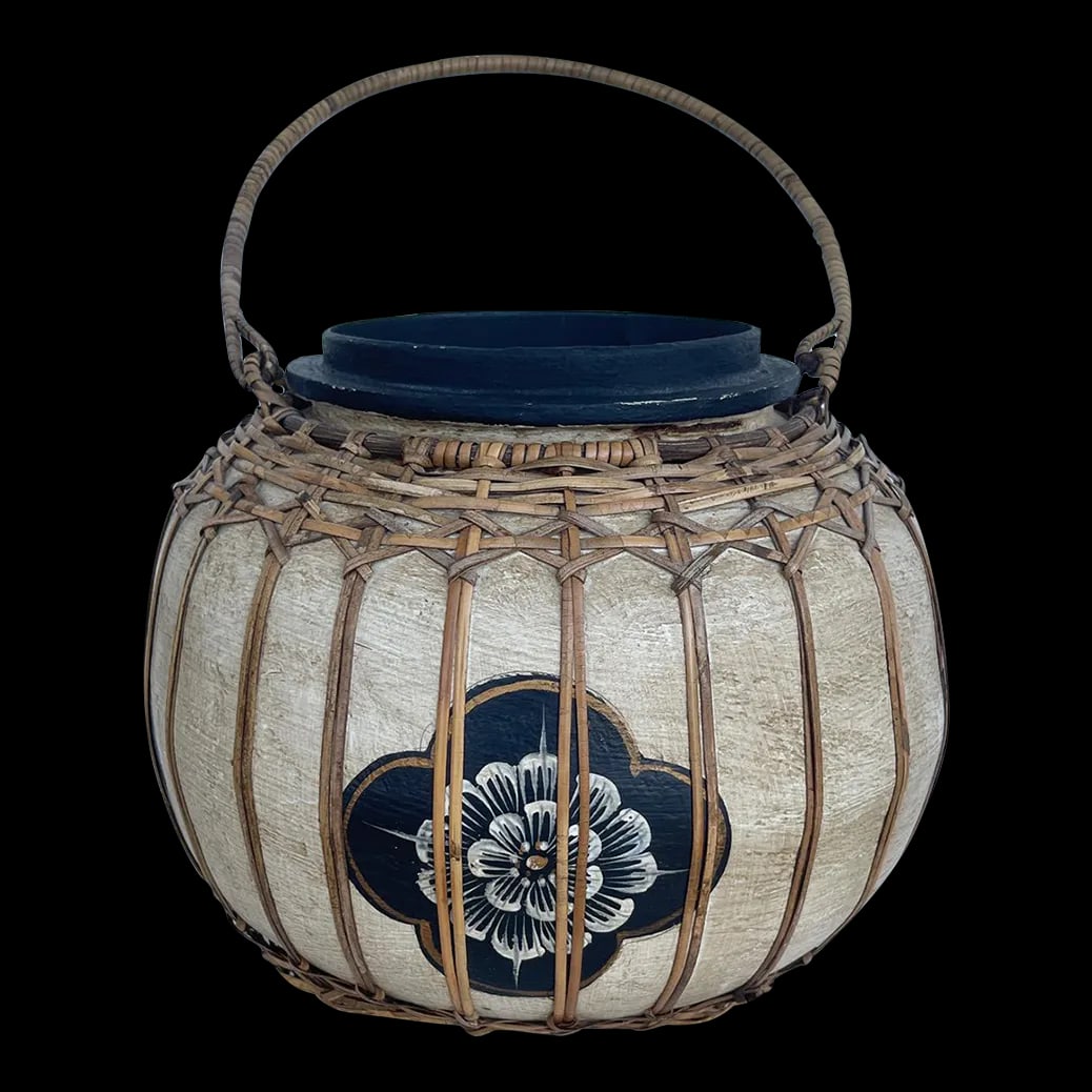 Vintage Asian Paper Mache Rattan Wrapped Container With Handle: Vintage Asian Paper Mache Storage Container with wrapped rattan design and handle. Beige with black flower print and black wood base. I don't know if it there was a lid or not. Would look great with a