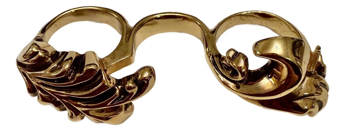 1990s Retro Versace Three-Finger Brass Knuckle Ring in Antique Gold: Retro Versace antiqued gold metal three-finger ring with Medusa logo and foliate detailing. Each ring is a different US size with the left being 7.25, the center being 3.75, and the right ring being