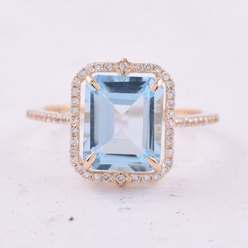 4.17 Ct Octagon Blue Topaz 9K Gold Ring: 4.17 Total Carat Blue Topaz 9K Gold Ring Specifications: Total Weight 2.439 g Center Gemstone Blue Topaz Gemstone Carat Weight 3.92 Carats Gemstone Measurements 10X8 mm Additional Gemstones White