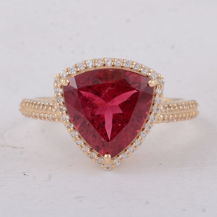 3.62 Ct Trillion Tourmaline 9K Gold Ring: 3.62 Total Carat Tourmaline 9K Gold Ring Specifications: Total Weight 2.71 g Center Gemstone Tourmaline Gemstone Carat Weight 3.28 Carats Gemstone Measurements 10X10 mm Additional Gemstones White