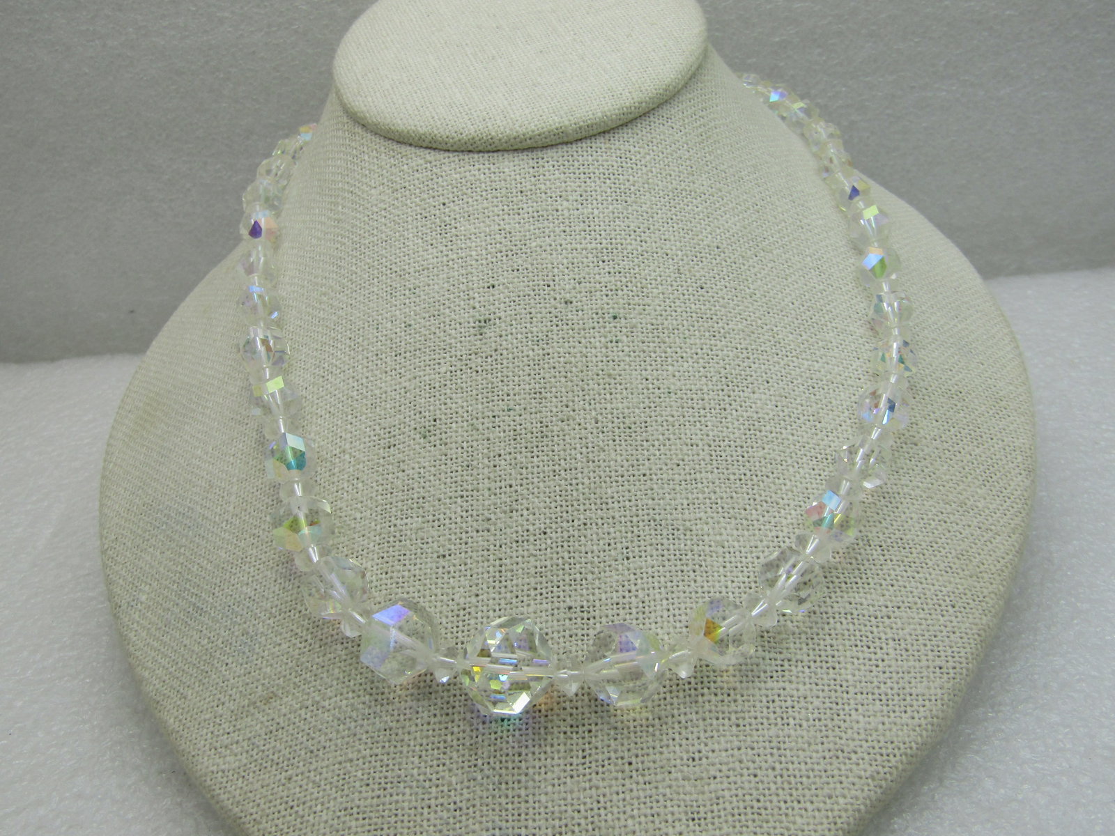Vintage Aurora Borealis Crystal Necklace, 21", Graduated Beads: Vintage Aurora Borealis Crystal Necklace, 21", Graduated Beads from 6mm round faceted beads to 14mm. Hook clasp. There are diamond-shaped spacer beads between the round faceted beads. Mid-century.