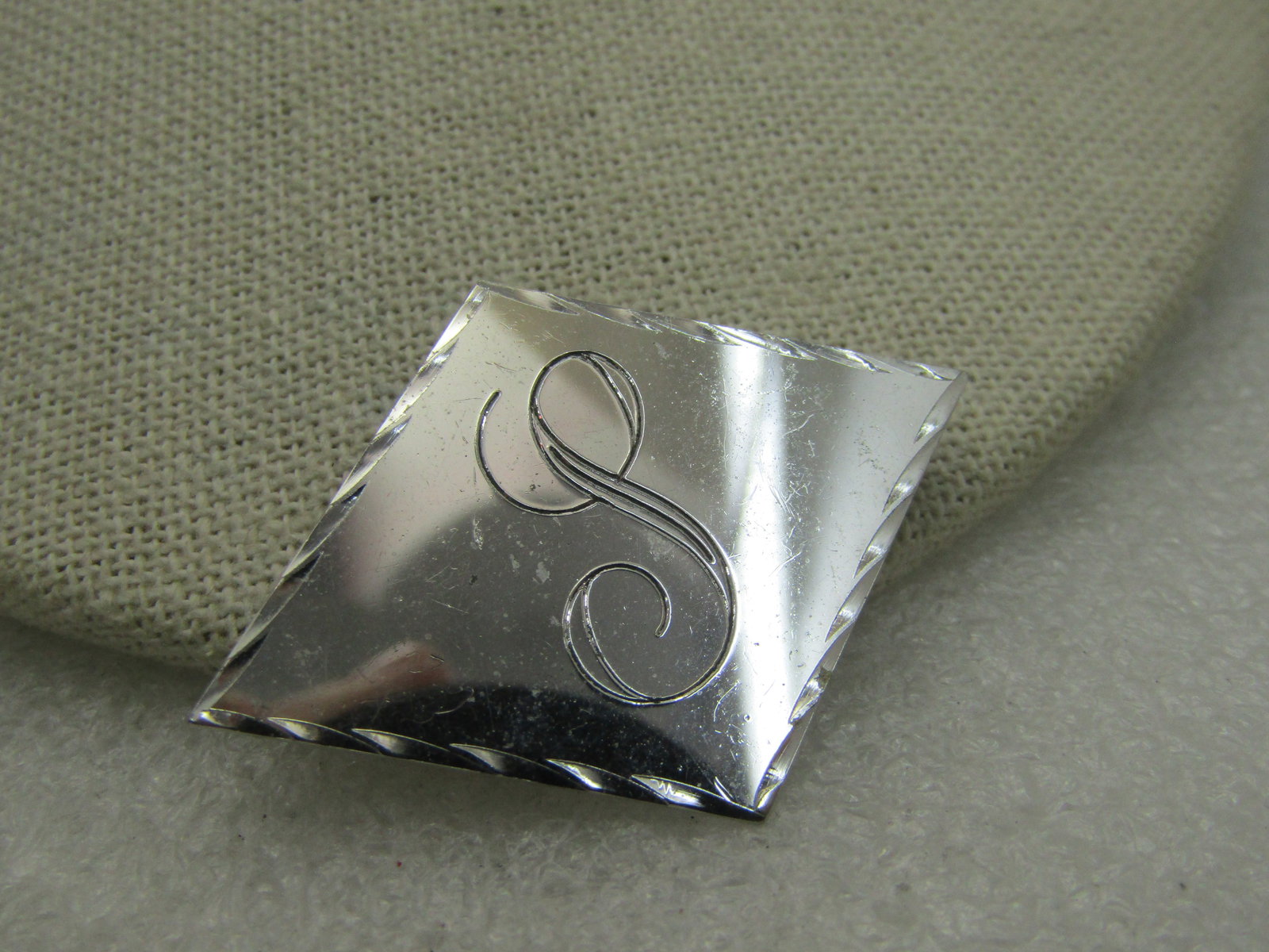 Vintage Sterling Silver Initial S Diamond Shaped Brooch, Signed Wells: Vintage Sterling Silver Initial S Diamond Shaped Brooch, 1-7/8" wide and 1.25" tall, weight is appx 8.18gr. 1960's-1970's. Signed Wells Ster and tested. Engraved notches around fram with a shiny and