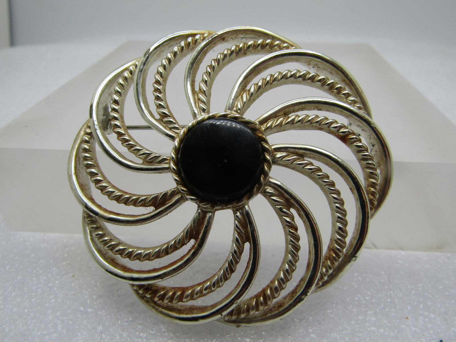 Vintage Spiral Brooch, Black Center, 2.5", 1960's-1970's, Sarah Coventry.: Vintage Spiral Brooch, Black Center, 2.5", 1960's-1970's. This has smother and rope accent spiral strands coming out fromt he center black acrylic cabochon that sits up slightly higher. It is