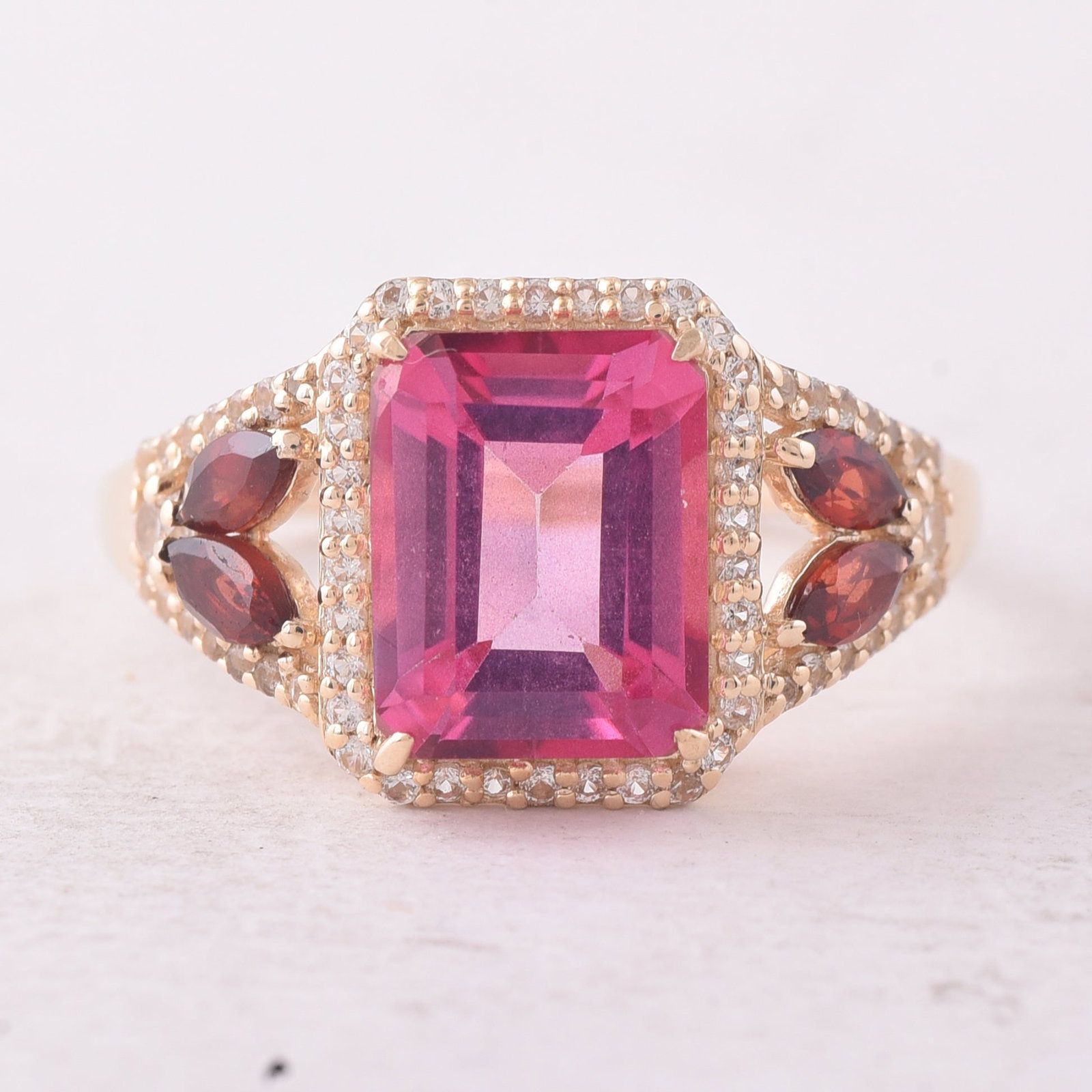 3.80 Ct Octagon Pink Topaz 9K Gold Ring: 3.80 Total Carat Pink Topaz 9K Gold Ring Specifications: Total Weight 2.619 g Center Gemstone Pink Topaz Gemstone Carat Weight 2.91 Carats Gemstone Measurements 9X7X4.80 mm Additional Gemstones Garnet