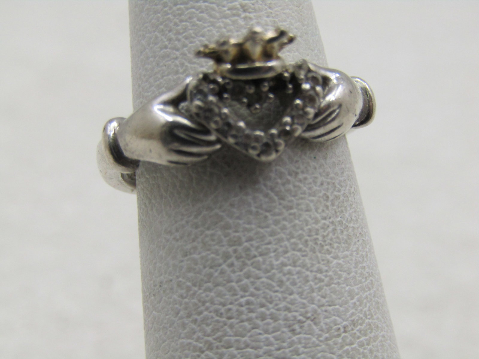 Vintage Sterling Rhinestone Claddagh Ring. Sz 4.5: Vintage Sterling Rhinestone Claddagh Ring. Sz 4.5. The heart is a rhinestone halo with pointed crown. 8mm down the finger. The band is appx. 2.2mm wide. Under magification it appears two rhinestones h