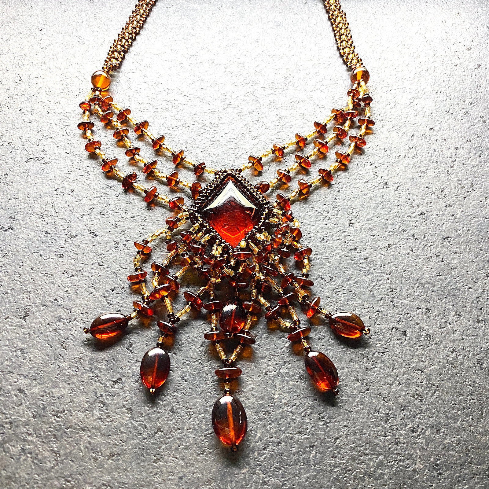 Grand Amber Floral Necklace made from leaf like bead ornaments: Title:Grand Amber Floral Necklace made from leaf like bead ornaments Metal:NoneGemstone:AmberWeight:23.1 gSize:Size: 480.0 x 90.0 x 10.0 mm Size: 18.898 x 3.543 x 0.394 inches Made of:(Reconstituted