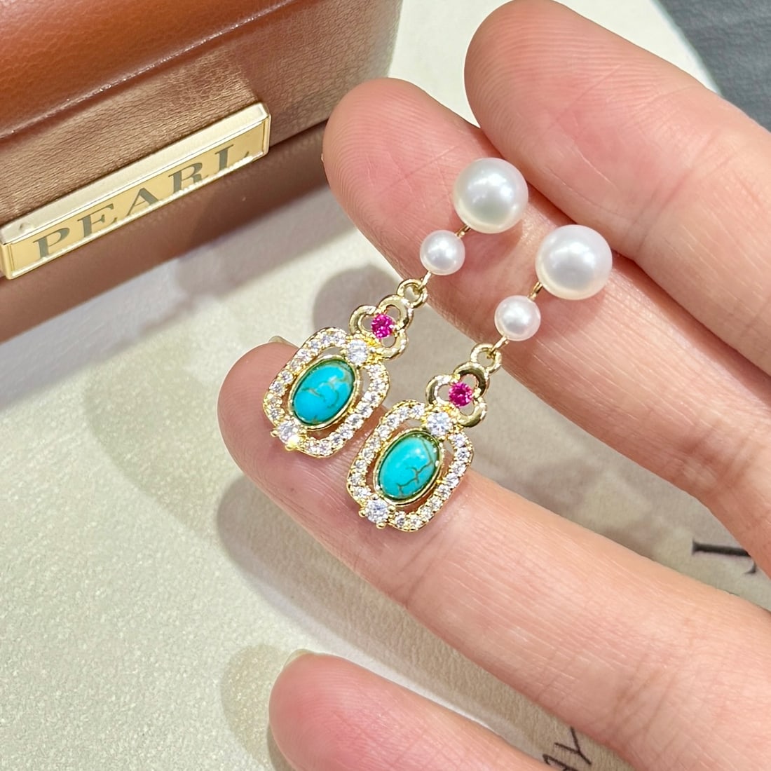 18K Gold Freshwater Pearl Earrings: Title: 18K Gold Freshwater Pearl Earrings Description: This pair of earrings features a captivating vintage design with turquoise accents, offering a unique double pearl gradient that enriches its lay