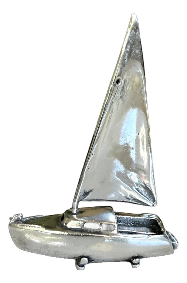 1980s Miniature Sterling Sailboat Sculpture – Handcrafted 925 Silver: Charming miniature sailboat sculpture, crafted entirely from 34 grams of solid 925 sterling silver. Measuring approximately 4 inches high, this elegant piece captures the sleek lines and spirit of a m