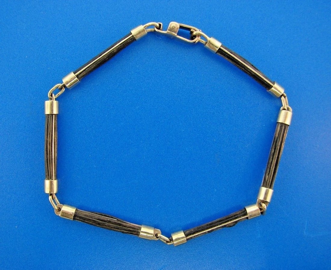 CHIC 9ct & Wood Bracelet Circa 1970s: Title: CHIC 9ct & Wood Bracelet Circa 1970s Description: DK9ct & Wood Bracelet · This is a must for any collector. · The weight is 7.7 grams. The length is 8 3/8 inches. The width is 1/8 of 