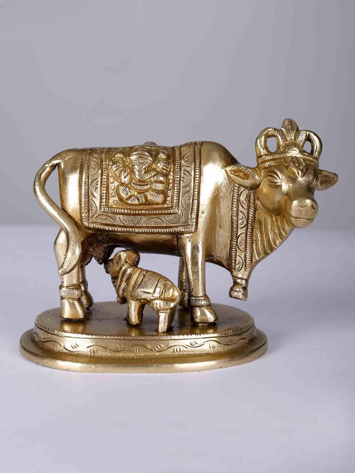 4" Small Goddess Kamdhenu Cow Idol with Calf | Brass statue: Title: 4" Small Goddess Kamdhenu Cow Idol with Calf | Brass statue Description: Goddess Kamadhenu, also known as “Surbhi”, the embodiment of boundless abundance and maternal grace, cradles