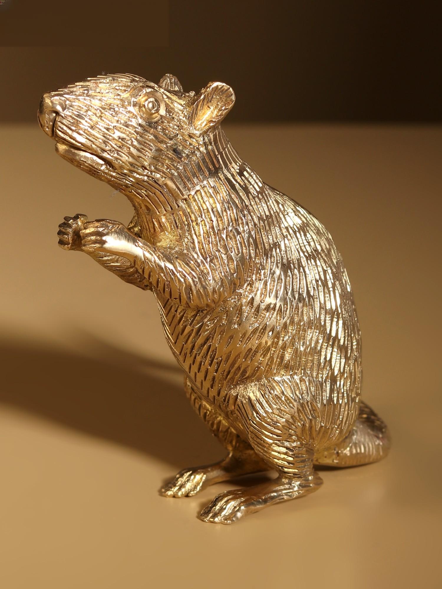 4" Small Ganesha's Rat Brass Figurine: Title: 4" Small Ganesha's Rat Brass Figurine Description: In this brass artwork, “Mushaka”, the beloved vehicle/mount of “Lord Ganesha”, embodies unwavering devotion and wisdom