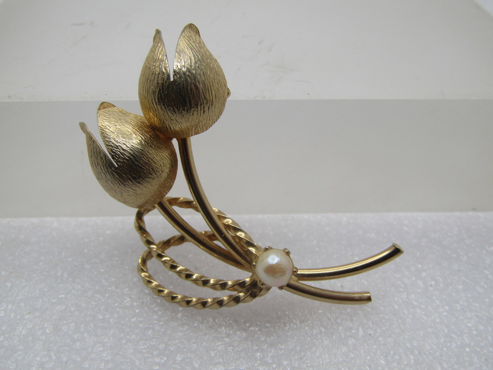 Vintage Double Floral Stem Brooch, Faux Pearl, 1960's: Vintage Double Floral Stem Brooch, Faux Pearl, 1960's. Gold tone textured curved floral blossoms with smooth stems and a 5mm faux pearl that is prong-set on the stems and a twisted double loop for the