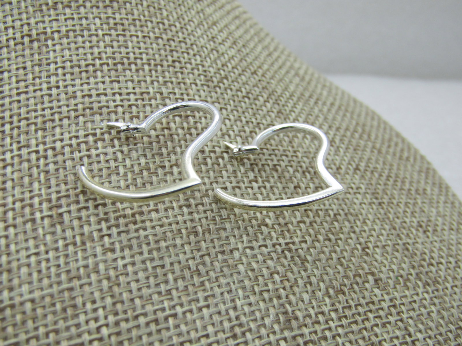 Vintage Sterling Heart Hoop Earrings, Pierced, 1", signed LA: Vintage Sterling Heart Hoop Earrings, Pierced, 1", signed LA, appx. 1.82 grams. 1" tall and wide. Hinged post that locks into the tubular design to complete the heart. Very good condition. (INV. WCOV.