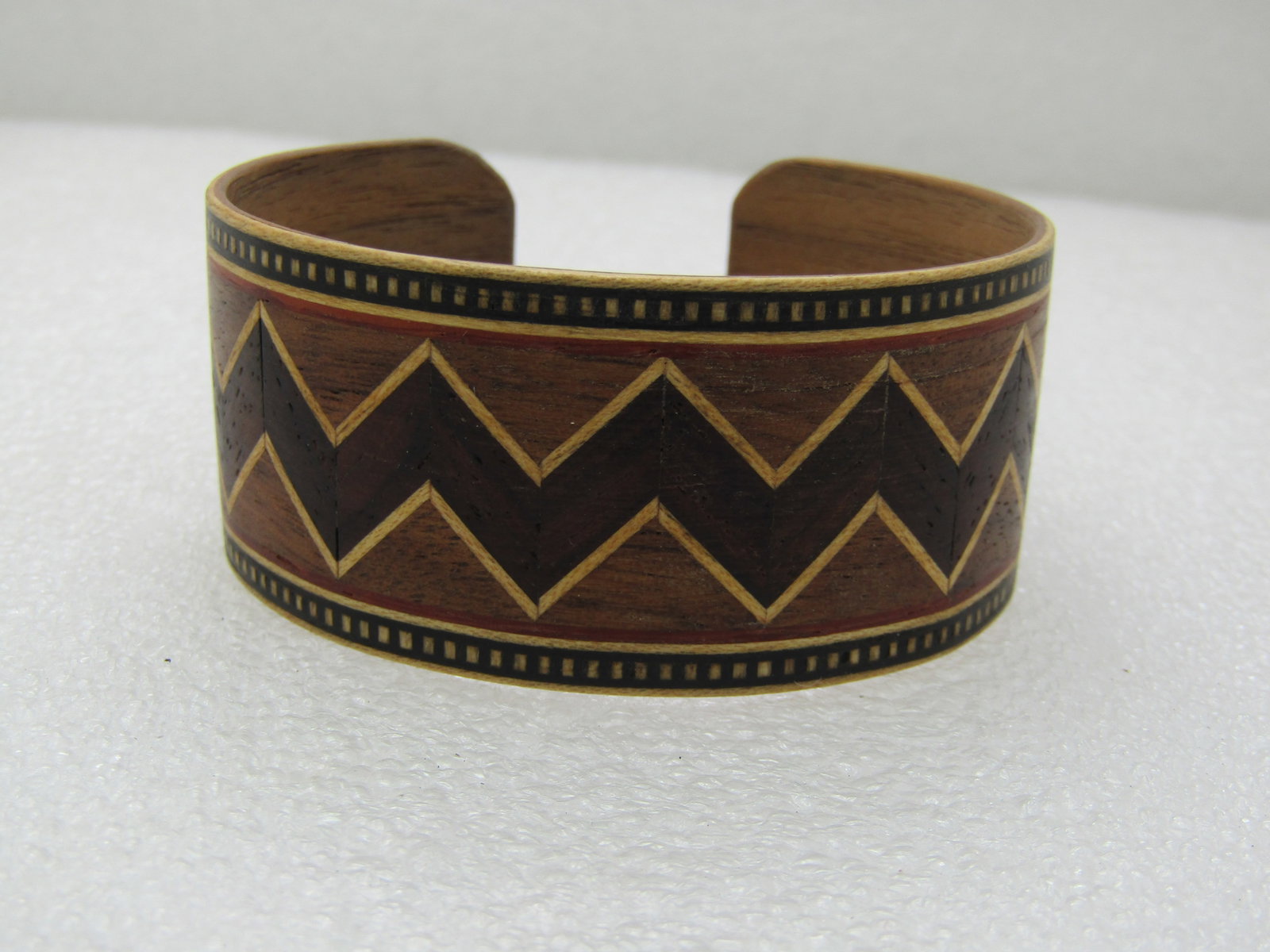 Vintage Tribal Inlaid Wooden Cuff Bracelet, 7.25", 1-1/8" Wide, Unisex: Vintage Tribal Inlaid Wooden Cuff Bracelet, 7.25", 1-1/8" Wide, Unisex. Opening is 2.5" by 2". Zig-zag inlaid design around the center of the bracelet with a dotted border. Done in shades of brown. Po