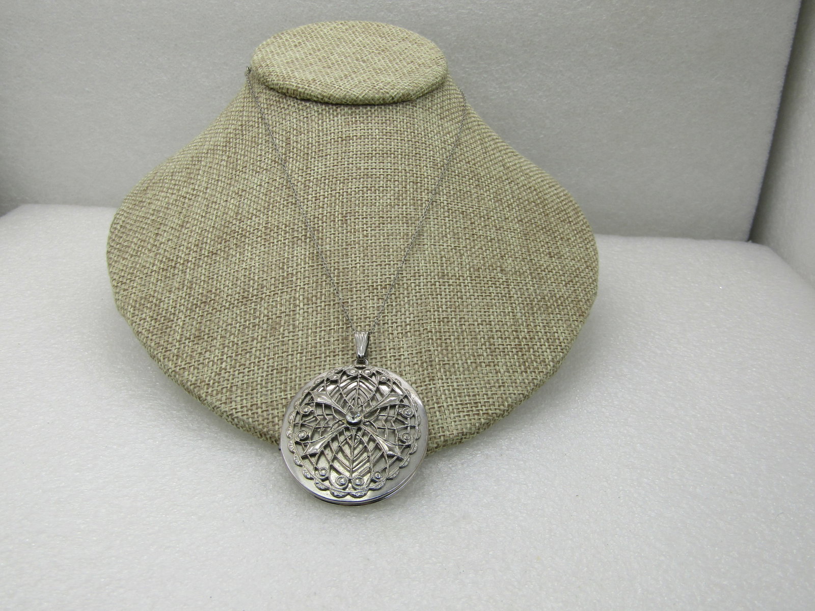 Vintage Filigree Locket Necklace, 16", Silver Tone: Vintage Filigree Locket Necklace, 16", Silver Tone, Rhinestone center, it almost is like a spider web on top - filigree overlaid with scalloped edge. The pendant is 2-3/8" long by 1.5" wide, hinged on