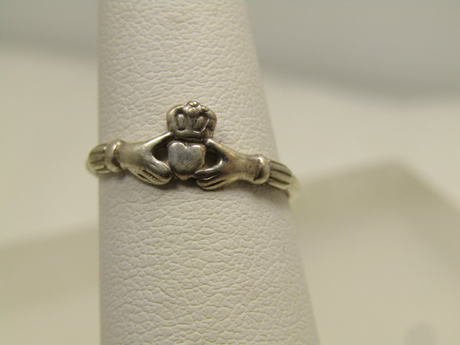 Vintage Sterling Claddagh Ring, Sz. 5, 1970's-1980's, Signed: Vintage Sterling Claddagh Ring, Sz. 5, 1970's-1980's, Signed. The maker's mark is a $ with a copyright mark. The ring is 6.5mm wide at the top center and tapers down to appx. 1mm at the back of the fi