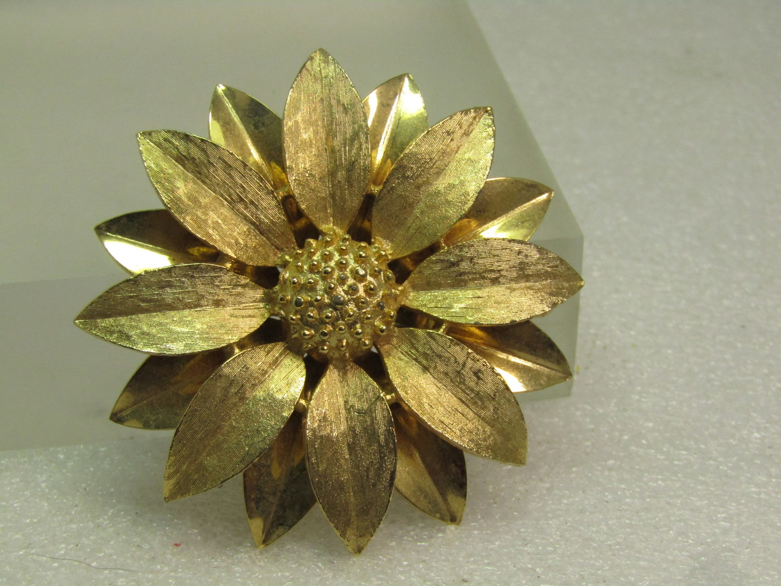 Vintage Sunflower Brooch, Sarah Coventry, Gold Tone, 1970's: Vintage Sunflower Brooch, Sarah Coventry, Gold Tone, 1970's. This is a two tiered petal design with the lower petals smooth and shiny and the pper textured . Domed center with a raised gold tone bumpy