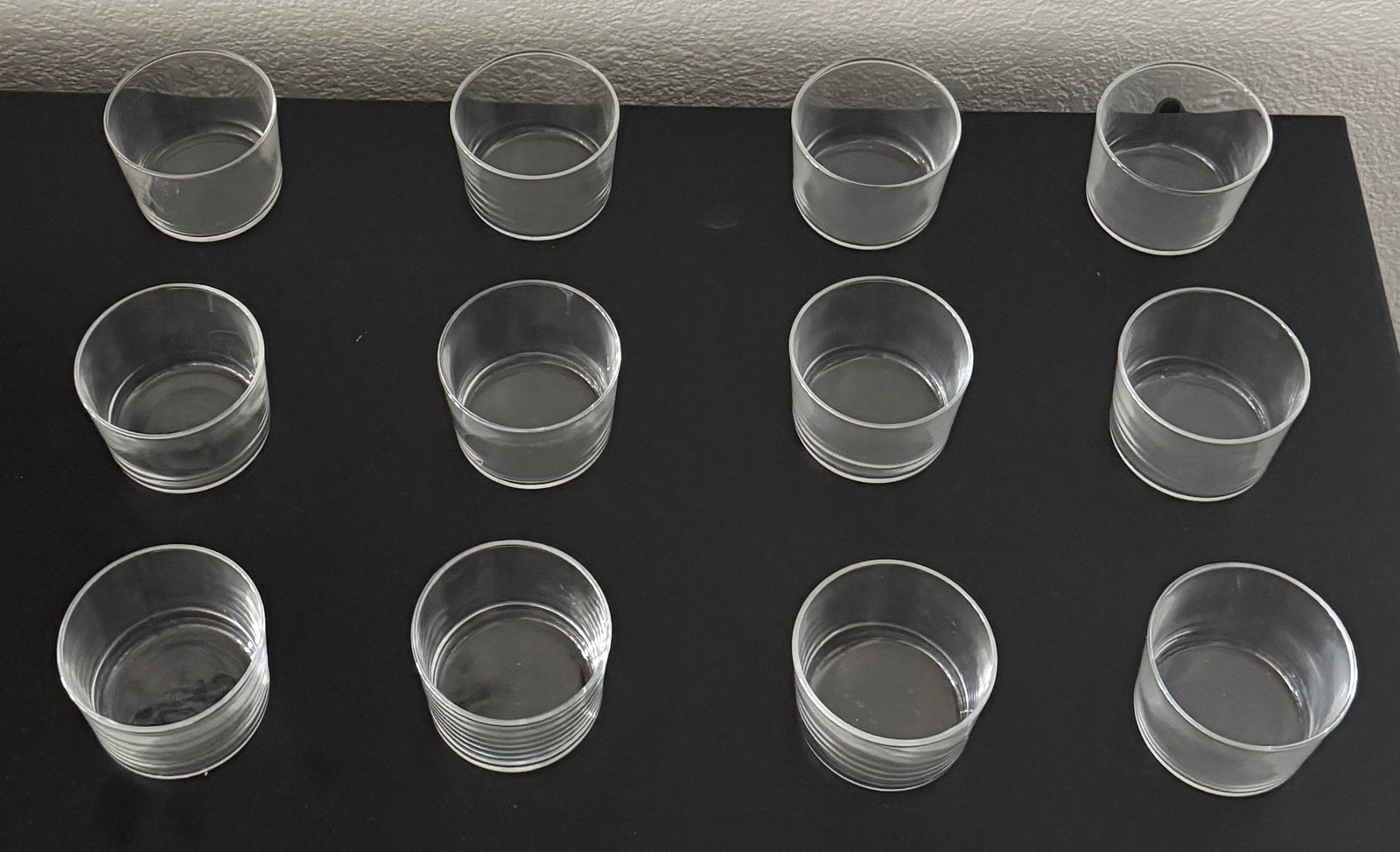 Set of Twelve Small Clear Glasses: A set of twelve small clear glasses, likely dating from the late 20th to early 21st century. Dimensions: Height - 2.5" Width - 3" Depth - 3" Weight - 6 lbs Your purchase is protected: In the rare even