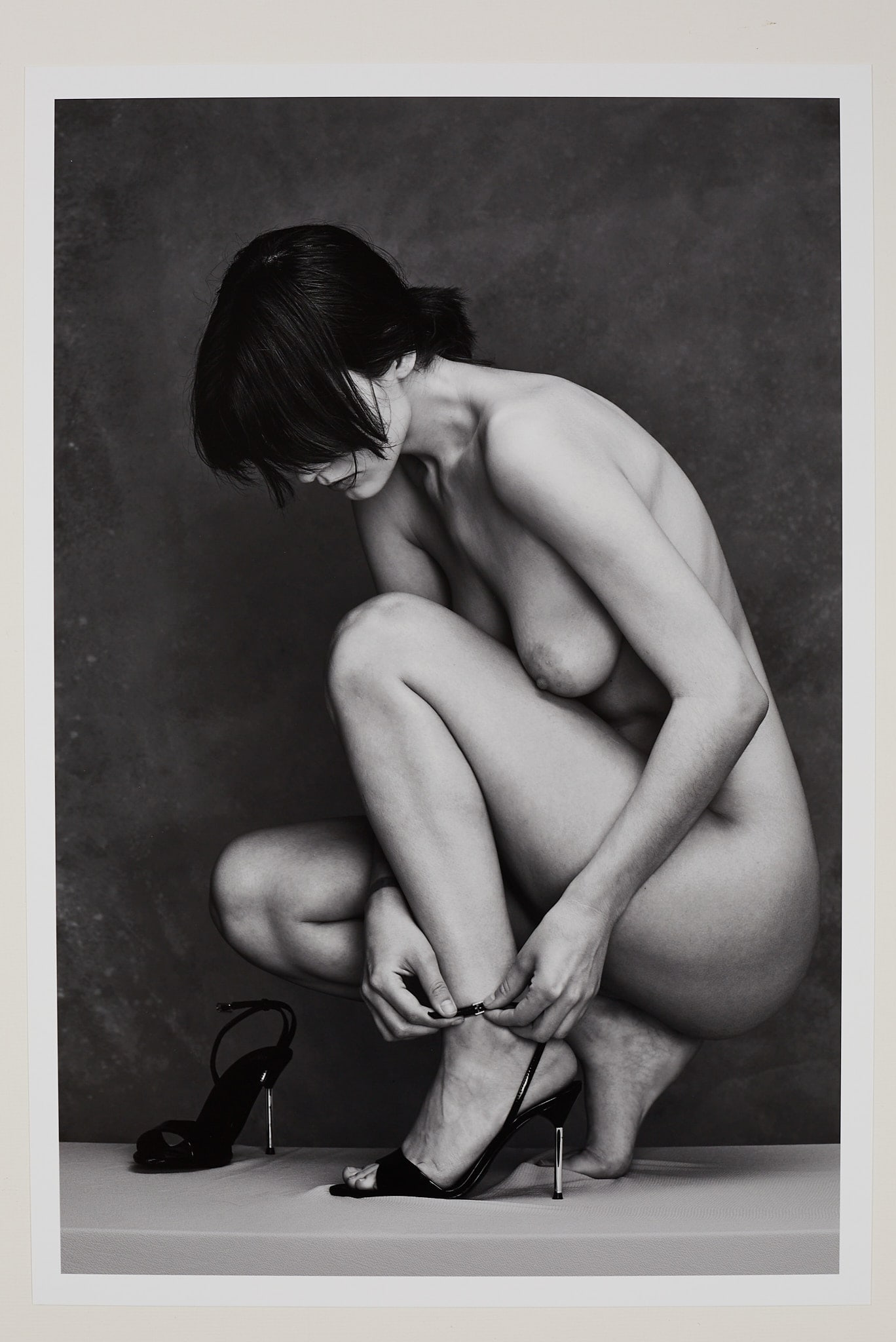 Strapping In 1/25 (2026): Artist: Spiros Politis (1969-) Title:"Strapping In" 1/25 (2026) Date: 2026 Materials:photography Size:19" x13" Description:"Strapping In "(2026)Model putting on her heels.Photographed in 2026 in Londo