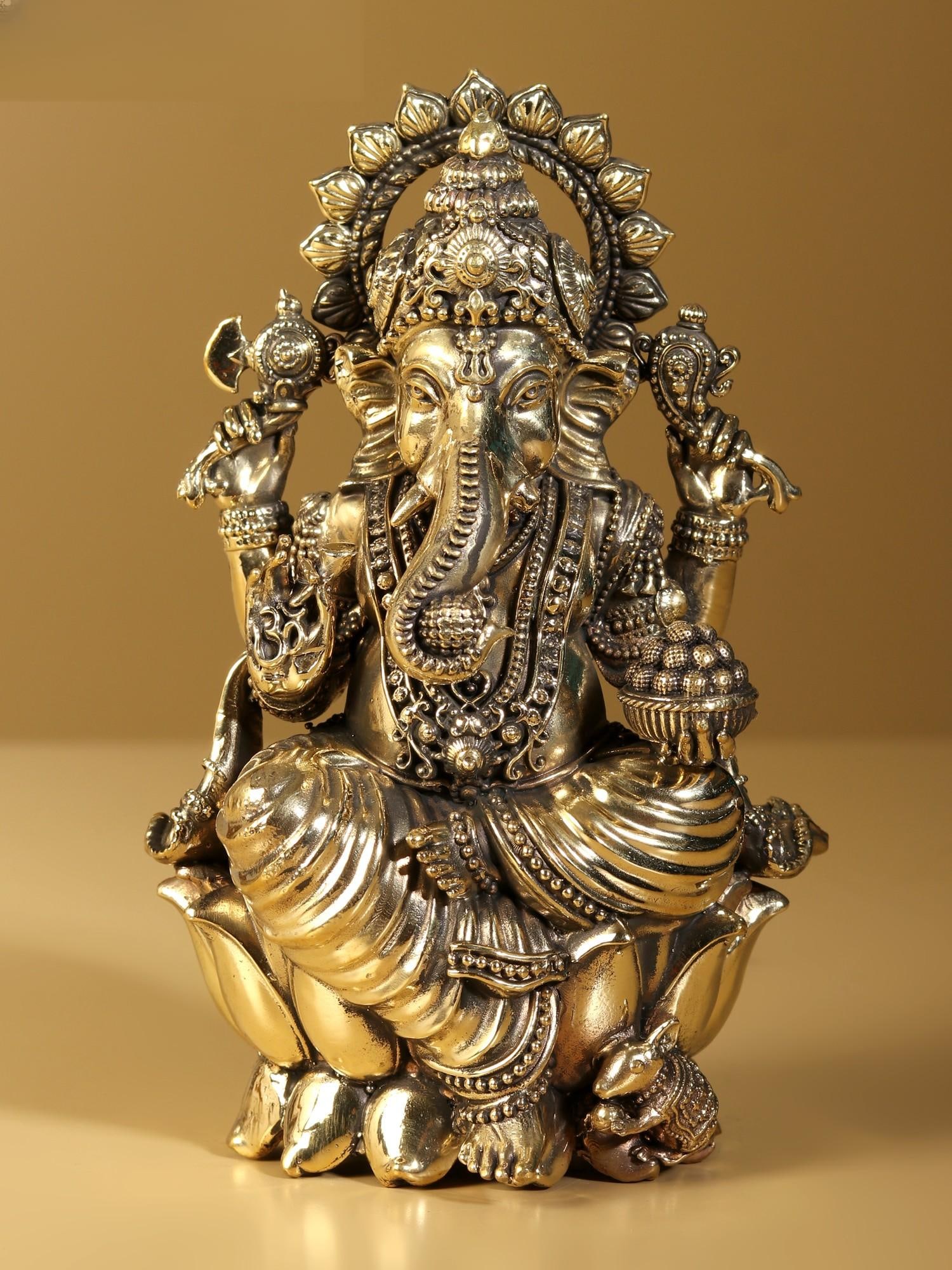 Superfine Lord Ganapati Brass Statue Seated on Lotus: Title: Superfine Lord Ganapati Brass Statue Seated on Lotus Description: A perfect icon of the embodiment of perfection- Lord Ganesha, this brass statue is an ideal image for worshipping and receiving