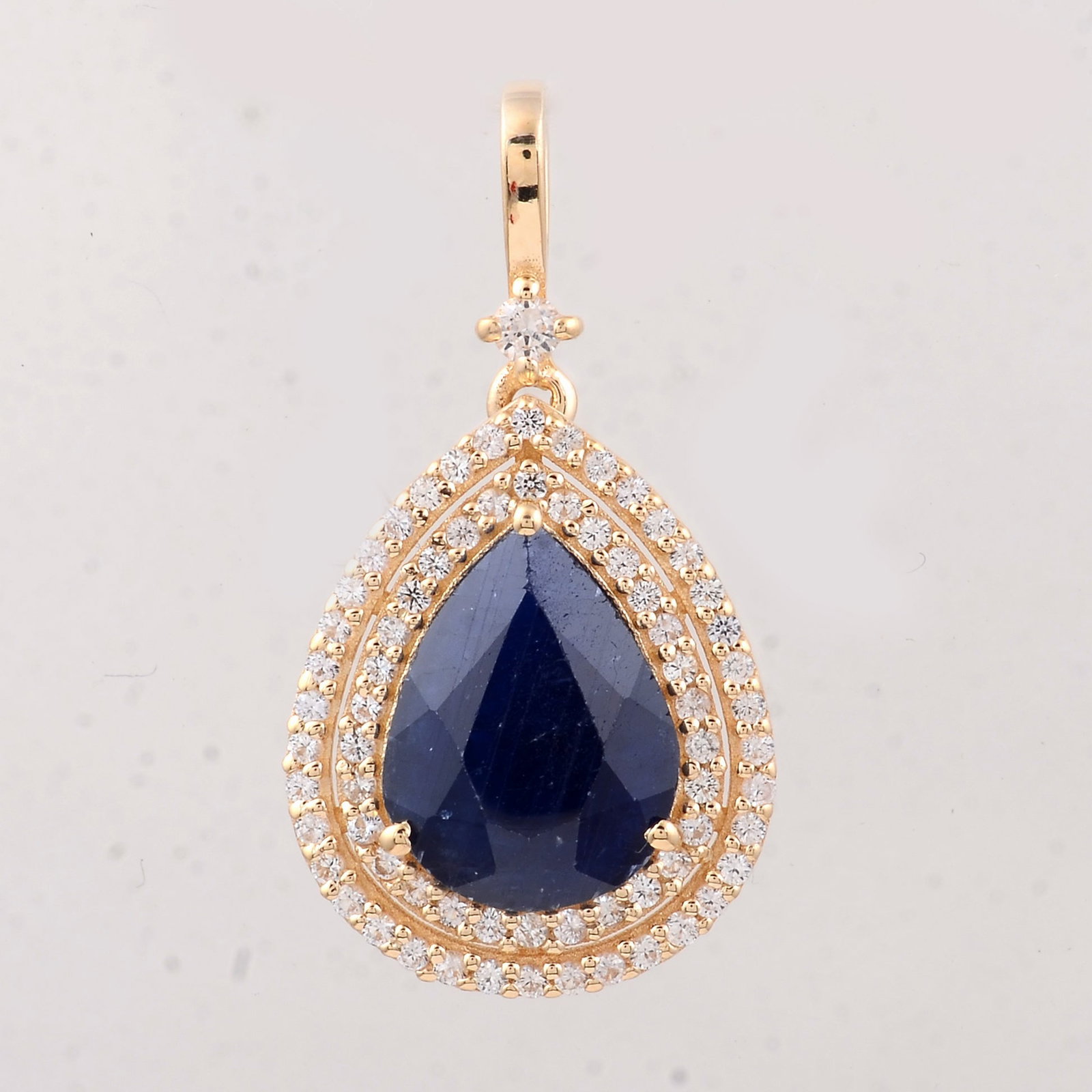 3.35 Ct Pear Sapphire 9K Gold Pendant: 3.35 Total Carat Sapphire 9K Gold Pendant Specifications: Total Weight 1.82 g Center Gemstone Sapphire Gemstone Carat Weight 3.04 Carats Gemstone Measurements 10.20X7.80X4.70 mm Additional Gemstones W