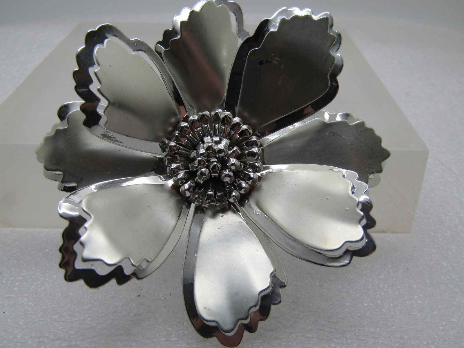 Vintage Tiered Blossom Brooch, Large, Cut-Out Frame 2.75", 1960's-1970's: Vintage Tiered Blossom Brooch, Large, Cut-Out Frame 2.75", 1960's-1970's. Silver tone in satiny and smooth and shiny with jagged solid petals that raise up slightly from the larger cut-out frame that
