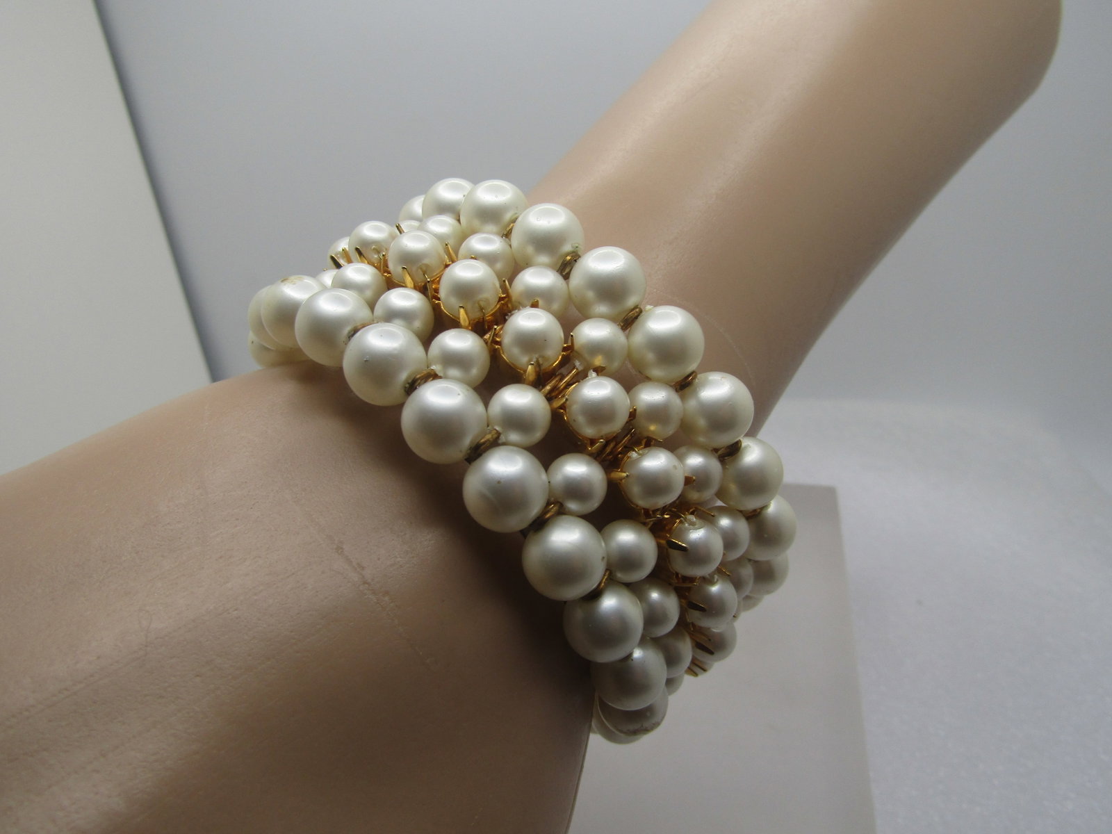 Vintage Faux Pearl Coiled Wrap Bracelet, Dangle Ends, 7" Plus, 1970's-1980's: Vintage Faux Pearl Coiled Wrap Bracelet, Dangle Ends, 7" Plus, 1970's-1980's. Fibe strands of faux pearls and appx. 1.25" wide. The pearls are wider on the ends at 7.5mm and appx. 6mm in the ot her