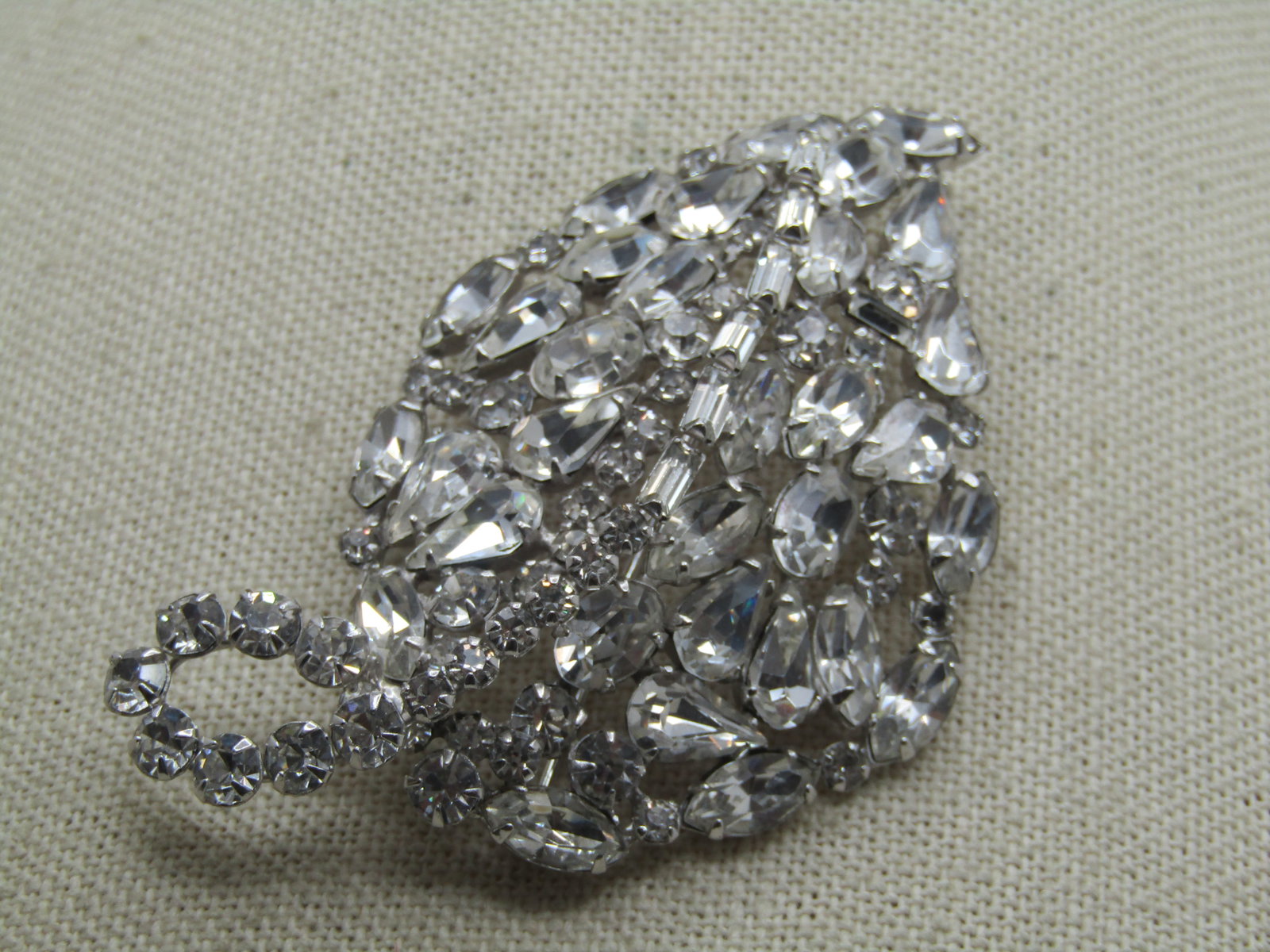 Vintage Rhinestone Leaf Brooch, Mixed Cuts, Mid-Century, 3": Vintage Rhinestone Leaf Brooch, Mixed Cuts, Mid-Century, 3" long and 1.75" wide. raised in the center - the center vein has round stones at the stem going to the beginning of the leaf and ends with ba