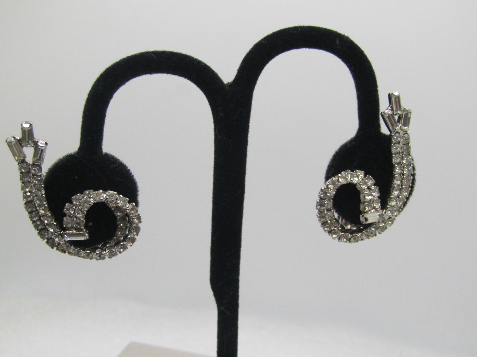 Vintage Rhinestone Double Coiled Earrings, Clip, 1960's-1980's: Vintage Rhinestone Double Coiled Earrings, Clip, 1960's-1980's. The ear rings are made of a double row of appx. 1.5mm round clear rhinestones that coil arround with a saggered end that has three bague