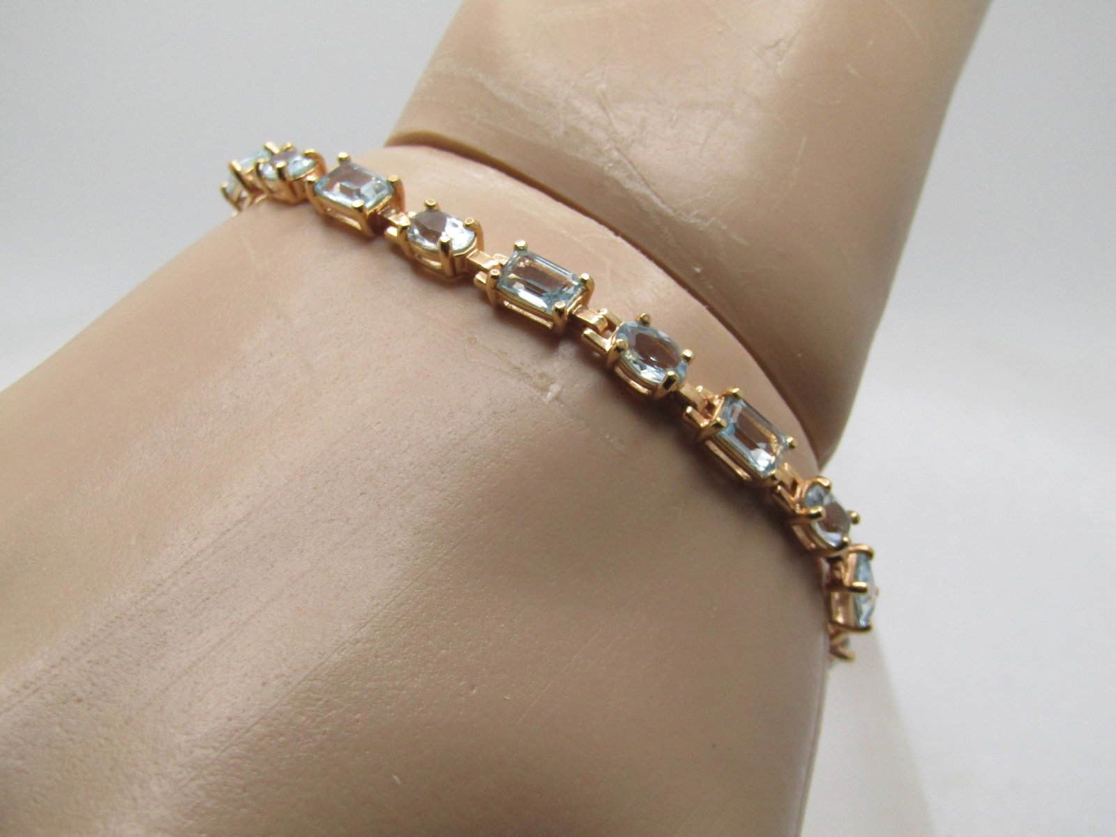 Sterling Vermeil Blue Topaz Bracelet, 7.5", 1980's-1990's, Signed: Sterling Goldwshed Blue Topaz Bracelet, 7.5", 1980's-1990's, Signed R. They have alternating oval and rectangular pale blue topaz stones. The ovals are appx. 6mm by 4mm and the rectangular are appx.