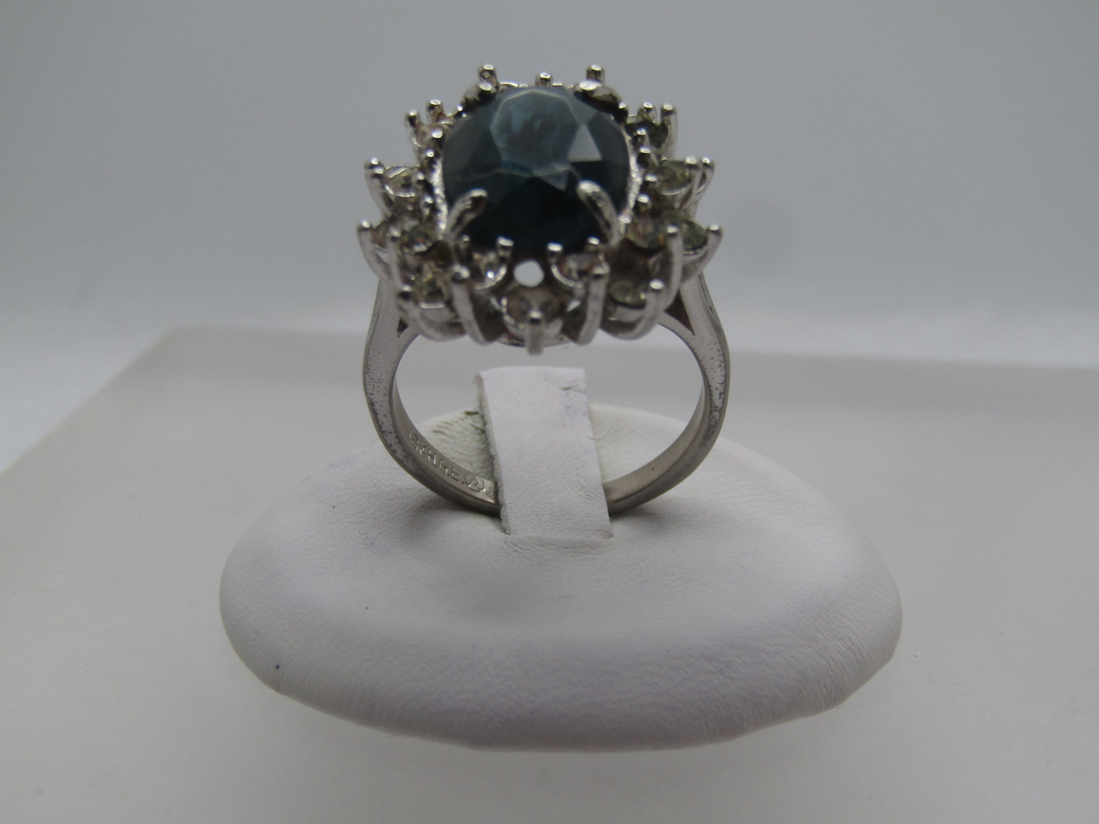 Vintage Blue & Clear RS Ring, Sz. 8.5, 18kt G.E.Plated, 1980's: Vintage Blue & Clear RS Ring, Sz. 8.5, 18kt G.E.Plated, 1980's. Signed by maker with A in circle. The main stone is deep blue and appx. 13.5mm by 9.5mm oval with a tiered halo of clear stones around t