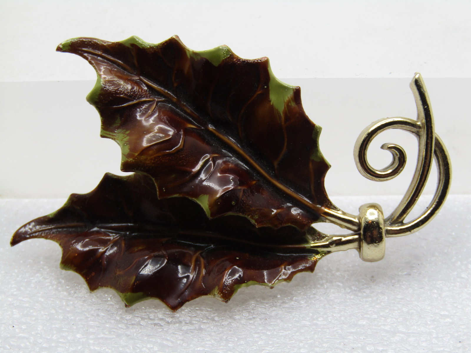 Vintage Enameled Brown/Green Holly Leaf Brooch, 2.75", 1960's: Vintage Enameled Brown/Green Holly Leaf Brooch, 2.75" by appx. 1.75" 1960's. Gold tone with nice detail on the leaves and not a flat design but raised and recessed in the center with curled stems. It 