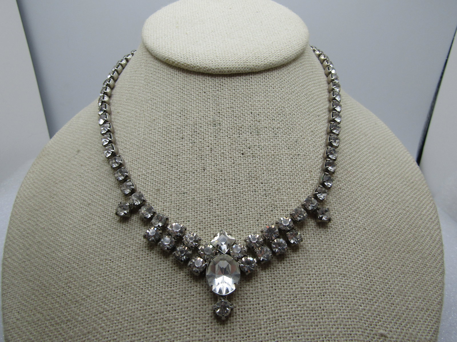 Vintage Rhinestone Slight Bib/Drop Necklace, 1940's, 15.5": Vintage Rhienstone Slight Bib/Drop Necklace, 1940's, 15.5". This has appx. 4.5mm round stones set in closed back settings with prongs cross the length of the necklace with a slight curve and drop at t