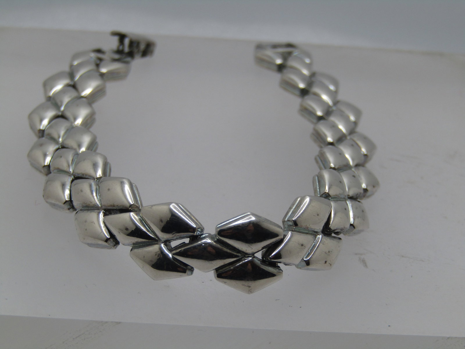 Vintage Diamond Shaped Link Bracelet, 7.75", 1970's-1980's: Vintage Diamond Shaped Link Bracelet, 7.75", 1970's-1980's. Linked bracelet with four staggered diamond shapes on each link. Flip clasp. It is appx. 1/2" wide. It is not signed by the maker. Very good