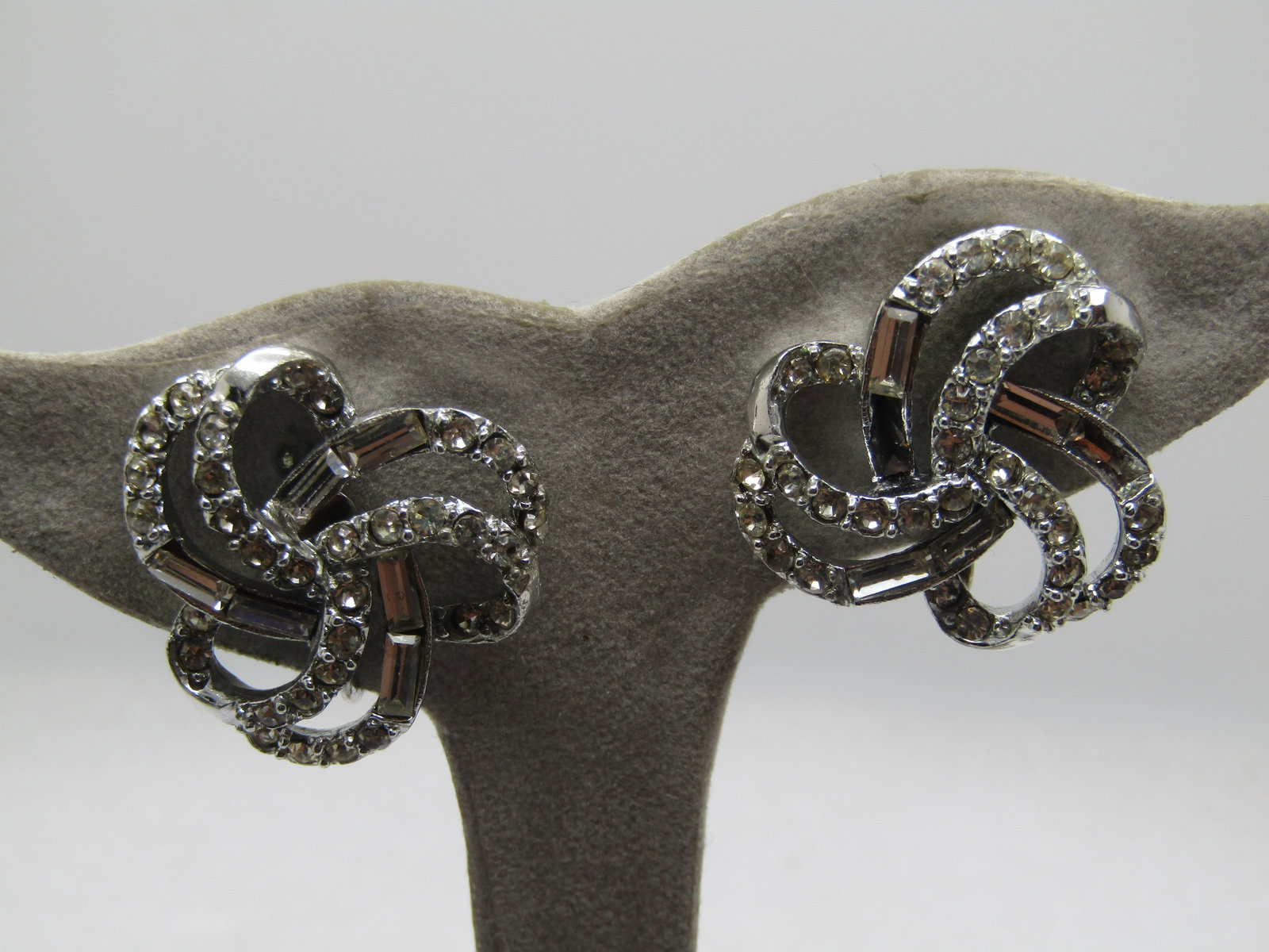 Vintage Looped Rhinestone Earrings, Clip, 1960's-1970's: Vintage Looped Rhinestone Earrings, Clip, 1960's-1970's. Baguettes and round clear rhienstones set in two rows with open space between with a triple loop design. They are silver tone and appx. 1" acro