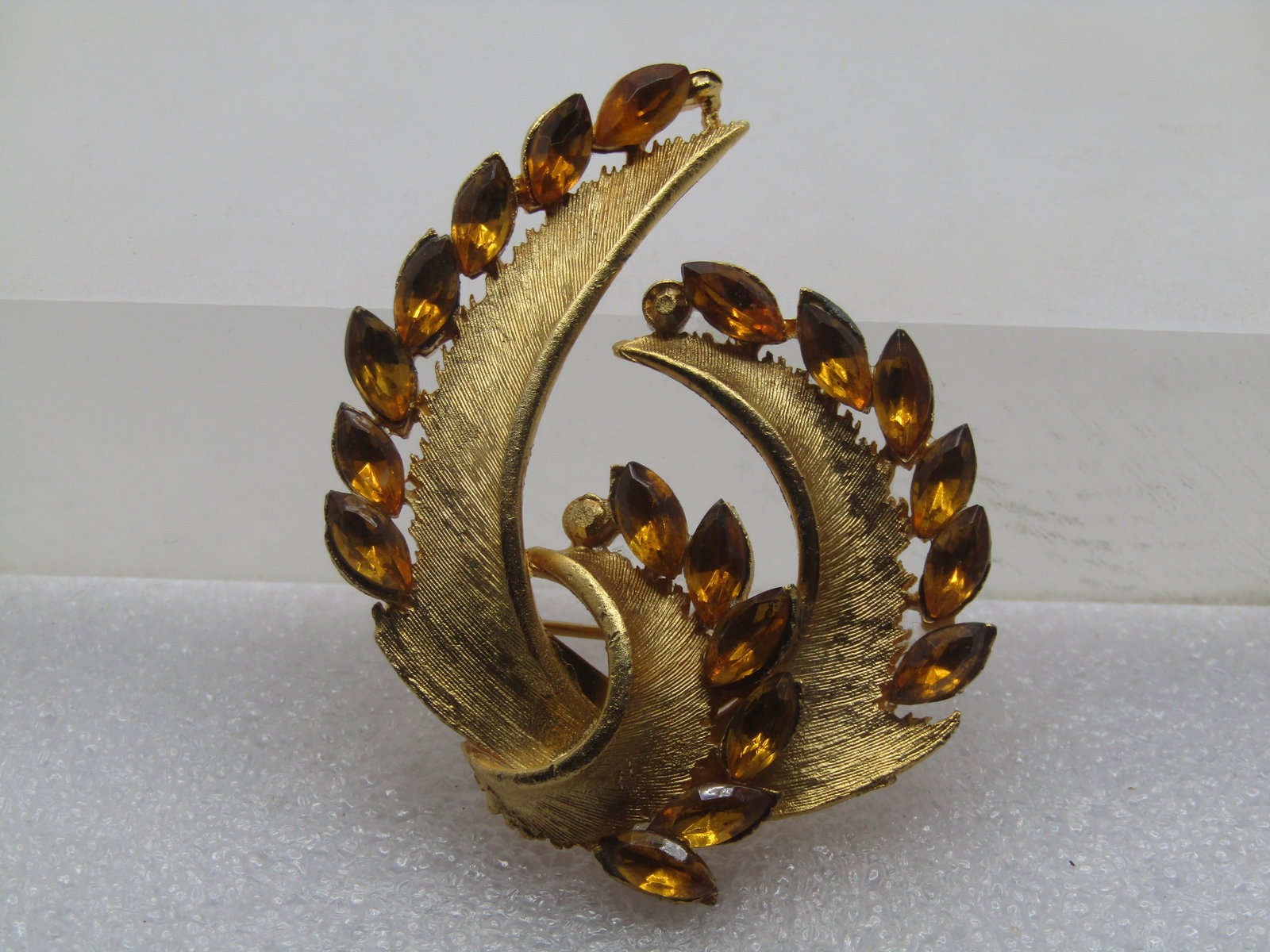 Vintage Marquise Rhinestone Mod Brooch, 1960's, Leafish: Vintage Marquise Rhinestone Mod Brooch, 1960's, Leafish. Textured gold tone with leaf-like swag and a center loop with marquise rhinestones on one edge of each of the drops and the center loop. The rh