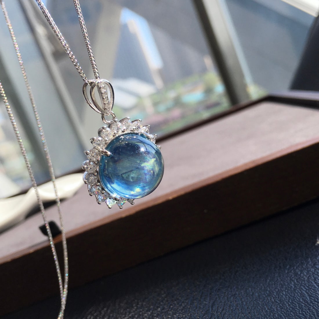 925 Silver Aquamarine Pendant: Title: 925 Silver Aquamarine Pendant Description: This pendant is meticulously set in 925 silver, showcasing the aquamarine's transparent crystal and dazzling devilish blue hue. The large diameter