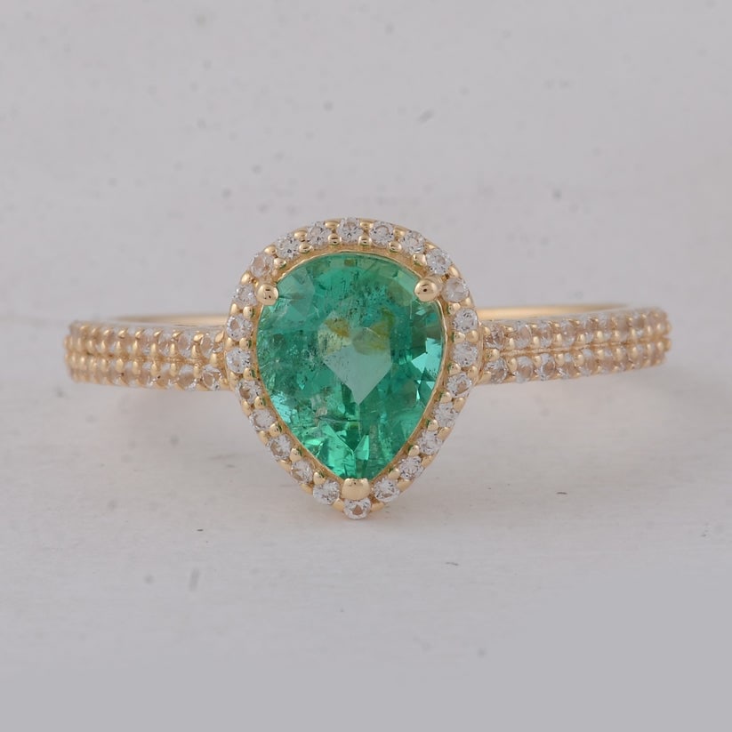 1.33 Ct Pear Emerald 9K Gold Ring: 1.33 Total Carat Emerald 9K Gold Ring Specifications: Total Weight 1.9 g Center Gemstone Emerald Gemstone Carat Weight 1.04 Carats Gemstone Measurements 7.60X6.20X4.20 mm Additional Gemstones White