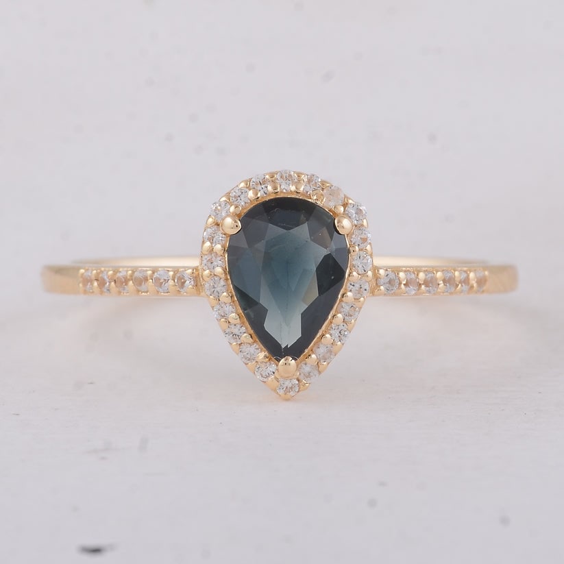 0.68 Ct Pear Sapphire 9K Gold Ring: 0.68 Total Carat Sapphire 9K Gold Ring Specifications: Total Weight 1.42 g Center Gemstone Sapphire Gemstone Carat Weight 0.54 Carats Gemstone Measurements 7X5X2.20 mm Additional Gemstones White
