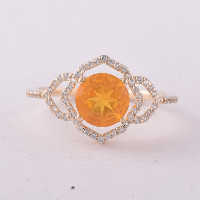 1.03 Ct Round Br.Opal 9K Gold Ring: 1.03 Total Carat Br.Opal 9K Gold Ring Specifications: Total Weight 1.74 g Center Gemstone Br.Opal Gemstone Carat Weight 0.8 Carats Gemstone Measurements 7 mm Additional Gemstones White Sapphire