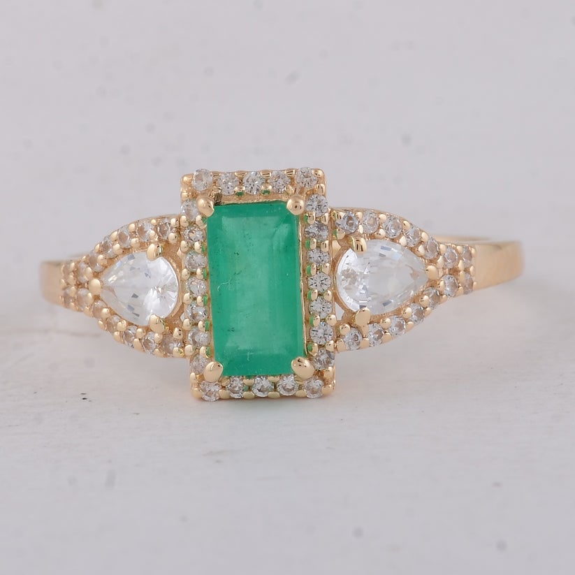 1.22 Ct Baguette Emerald 9K Gold Ring: 1.22 Total Carat Emerald 9K Gold Ring Specifications: Total Weight 1.82 g Center Gemstone Emerald Gemstone Carat Weight 0.68 Carats Gemstone Measurements 6.80X3.70X3.20 mm Additional Gemstones White